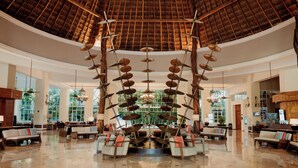 A spacious lobby with a high ceiling, large windows, and a central chandelier. - Catalonia Royal Tulum  Adults Only - All Inclusive (Xpu-Ha)