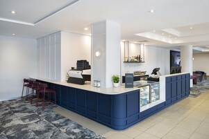 A reception area with a counter, seating, and a display case.