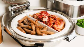 A buffet with a sign indicating 'Beef Sausage' and 'Bacon'.