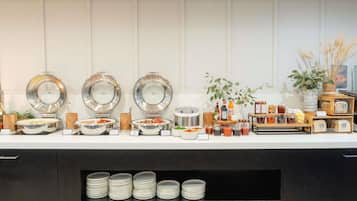 A buffet setup with various food items and beverages.