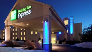 A Holiday Inn Express building with a prominent sign, a covered entrance, and a snow-covered ground. - Holiday Inn Express Hanover by IHG (Hanover)