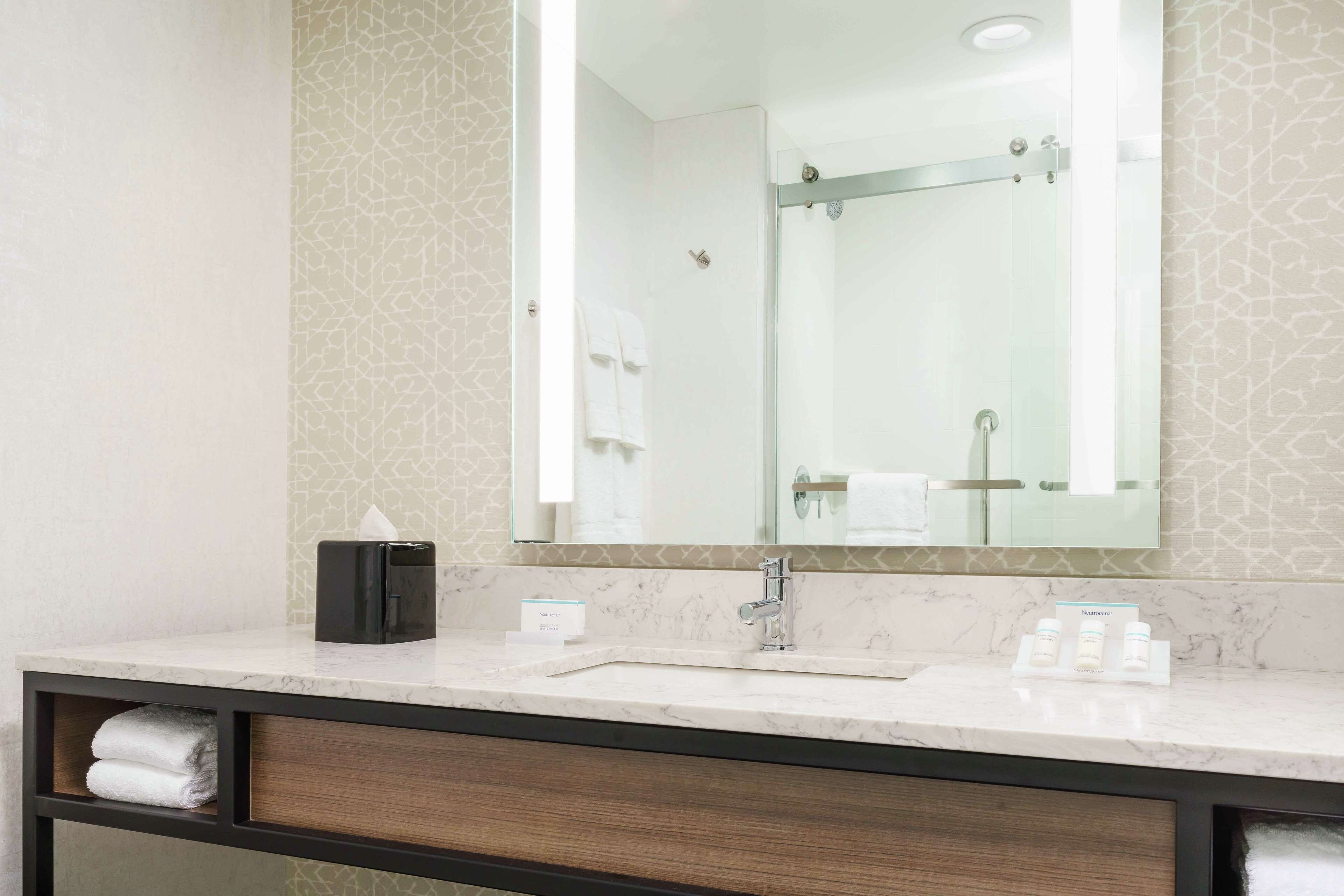 designer toiletries, hair dryer, towels