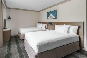 A hotel room with two beds, a flat-screen TV, a painting, and a desk with a lamp. - Hilton Garden Inn Annapolis Downtown (Annapolis)
