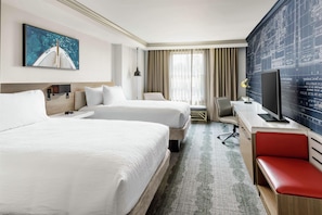 A hotel room with two beds, a desk, a television, and a large window with curtains. - Hilton Garden Inn Annapolis Downtown (Annapolis)