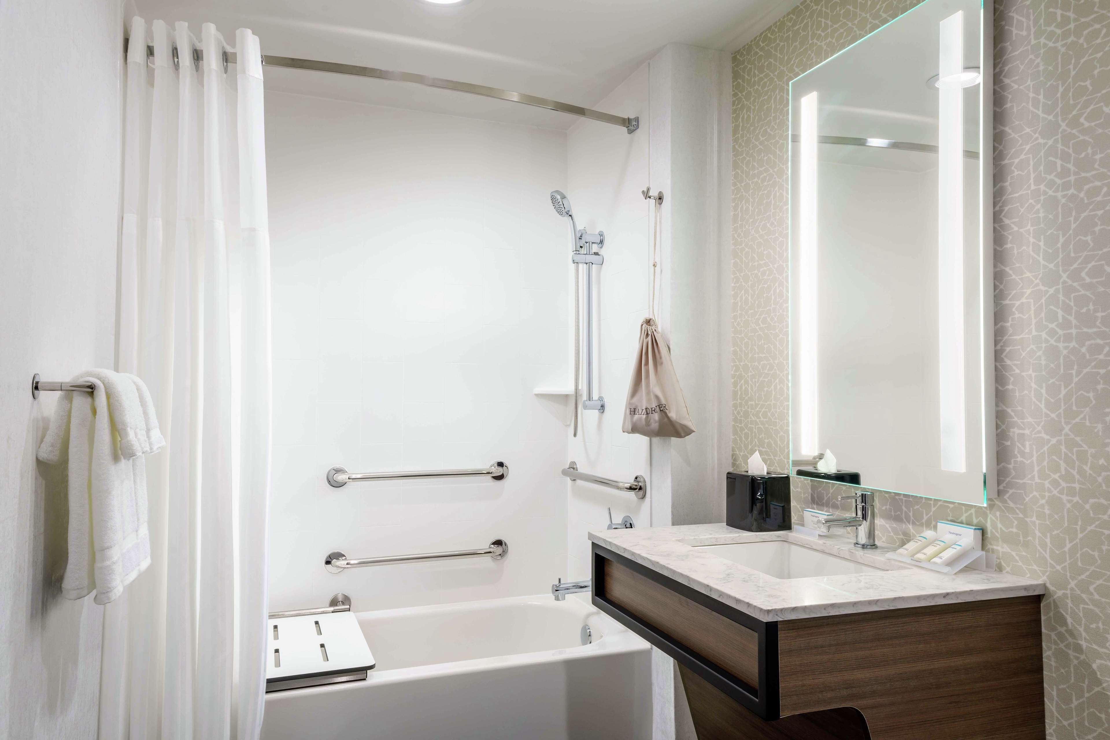 designer toiletries, hair dryer, towels