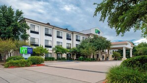 A Holiday Inn Express & Suites hotel with a parking lot and a covered entrance. - Holiday Inn Express & Suites Austin NW - Lakeline by IHG (Austin)