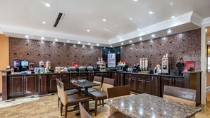 A restaurant with a brick wall backsplash, granite countertops, and a variety of seating options including booths and tables. - BW Plus Flagler Beach Area Inn & Suites (Palm Coast)