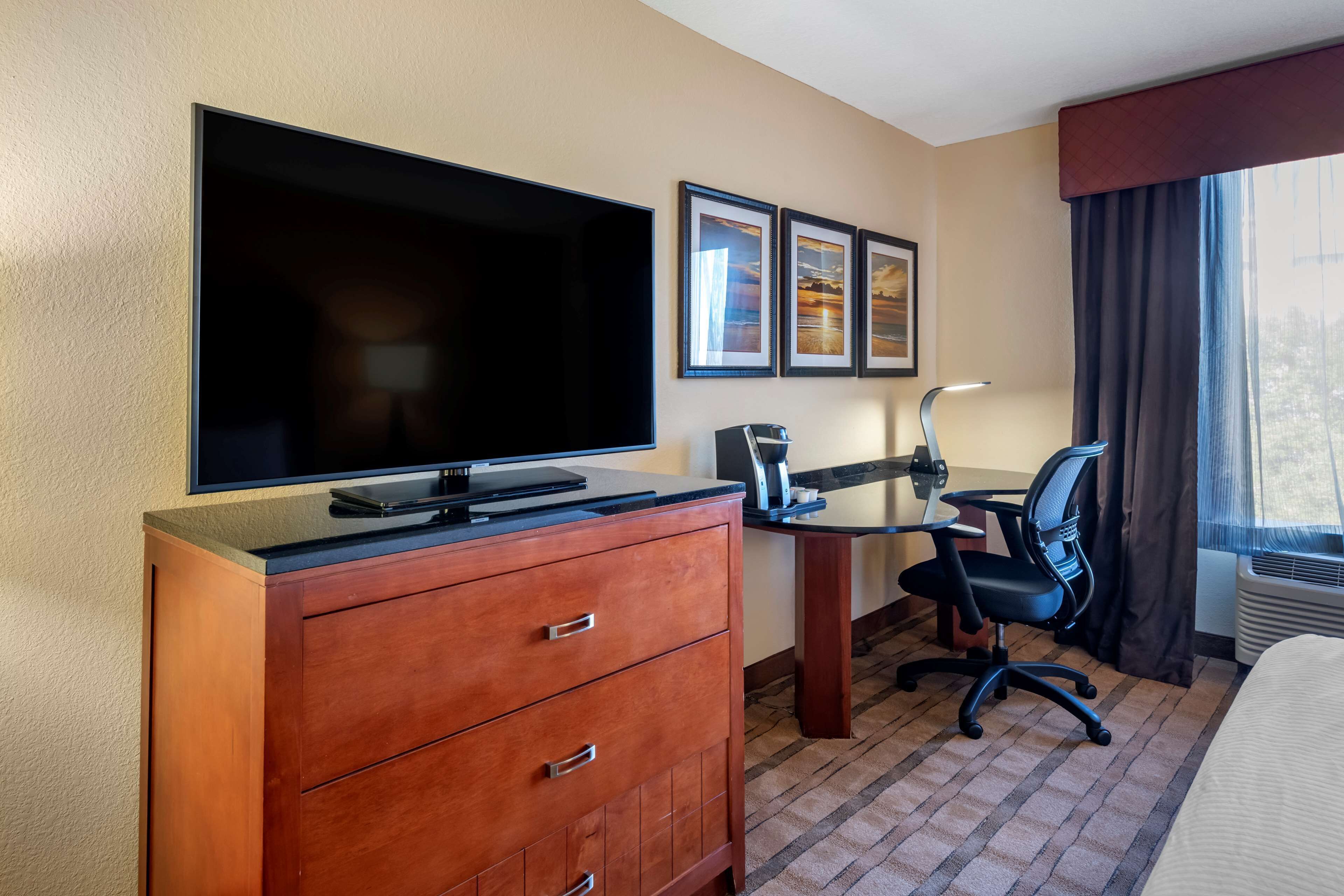 Premium bedding, desk, laptop workspace, blackout drapes