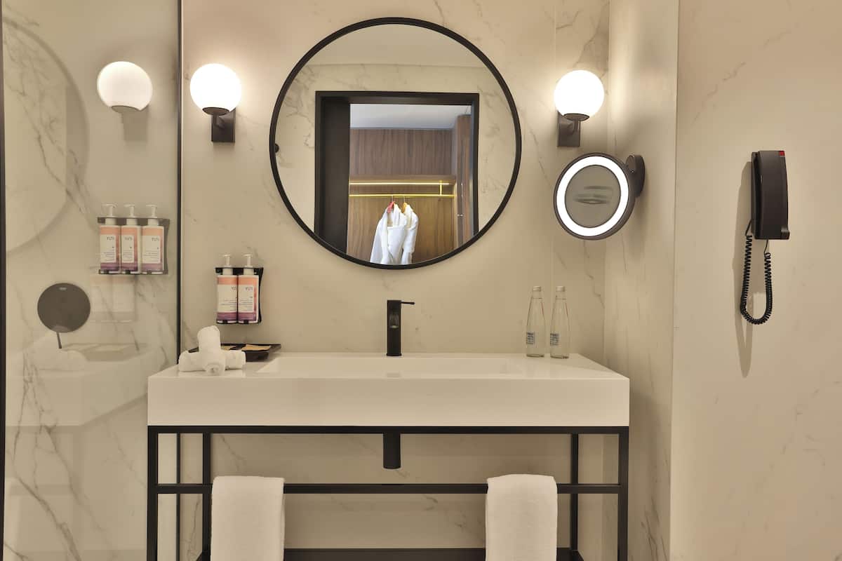 Eco-friendly toiletries, hair dryer, slippers, bidet