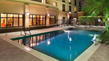 Relax by the pool surrounded by a deck and lounge chairs.