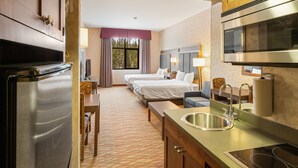 A hotel room with a kitchenette, a bed, a desk, and a bathroom. - The Lodge at Big Sky (Big Sky)