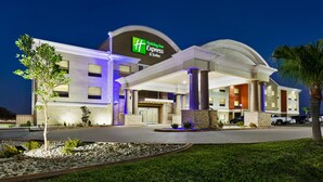 A Holiday Inn Express building with a modern design, featuring a prominent entrance and a well-lit facade. - Holiday Inn Express Hotel & Suites Mission-McAllen Area by IHG (Mission)