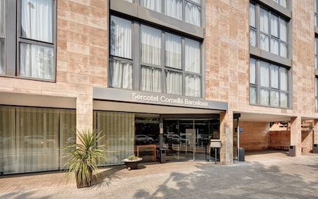 A hotel entrance with a sign reading "Sercotel Cornella Barcelona".