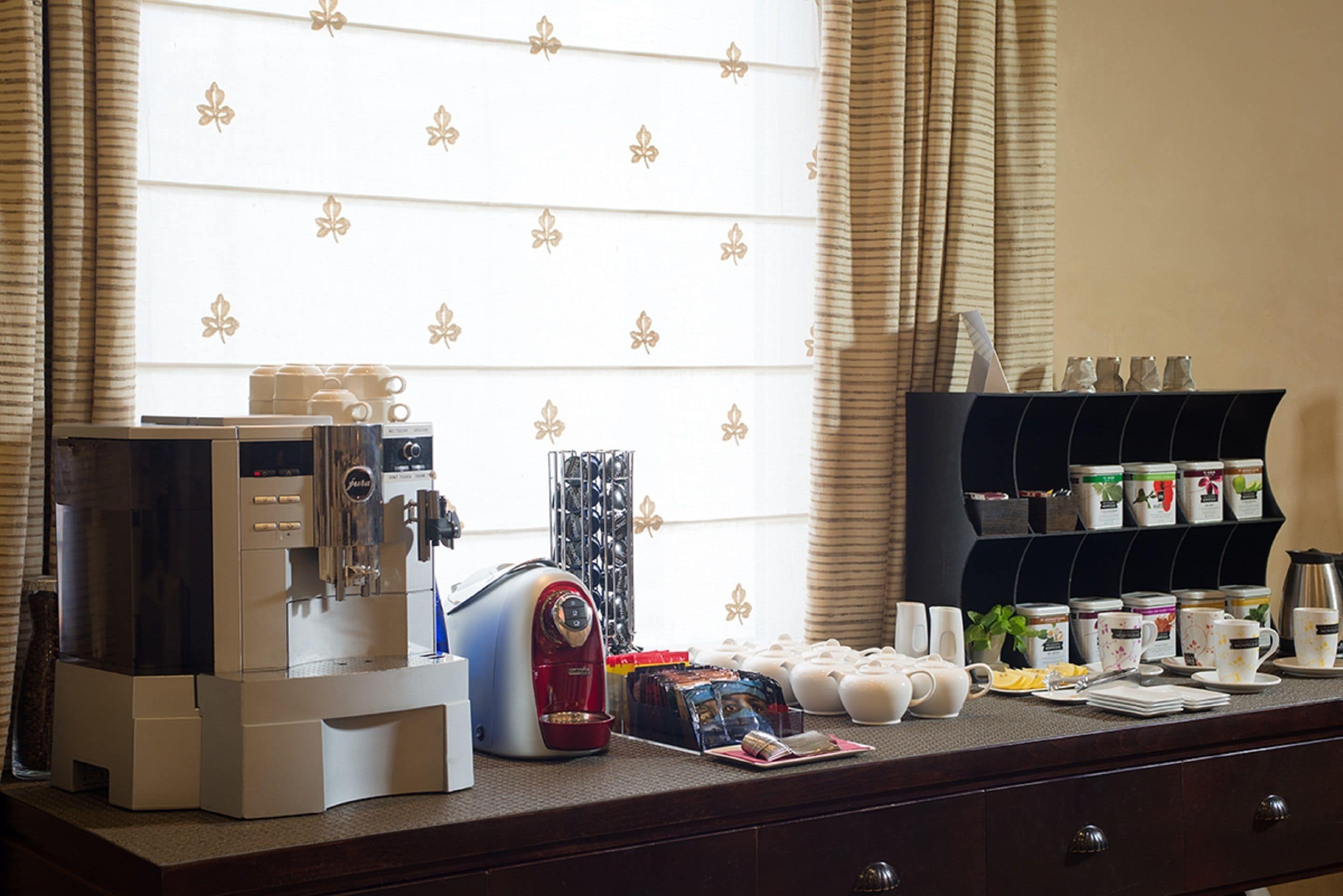A breakfast bar with a coffee machine, toaster, and various breakfast items.