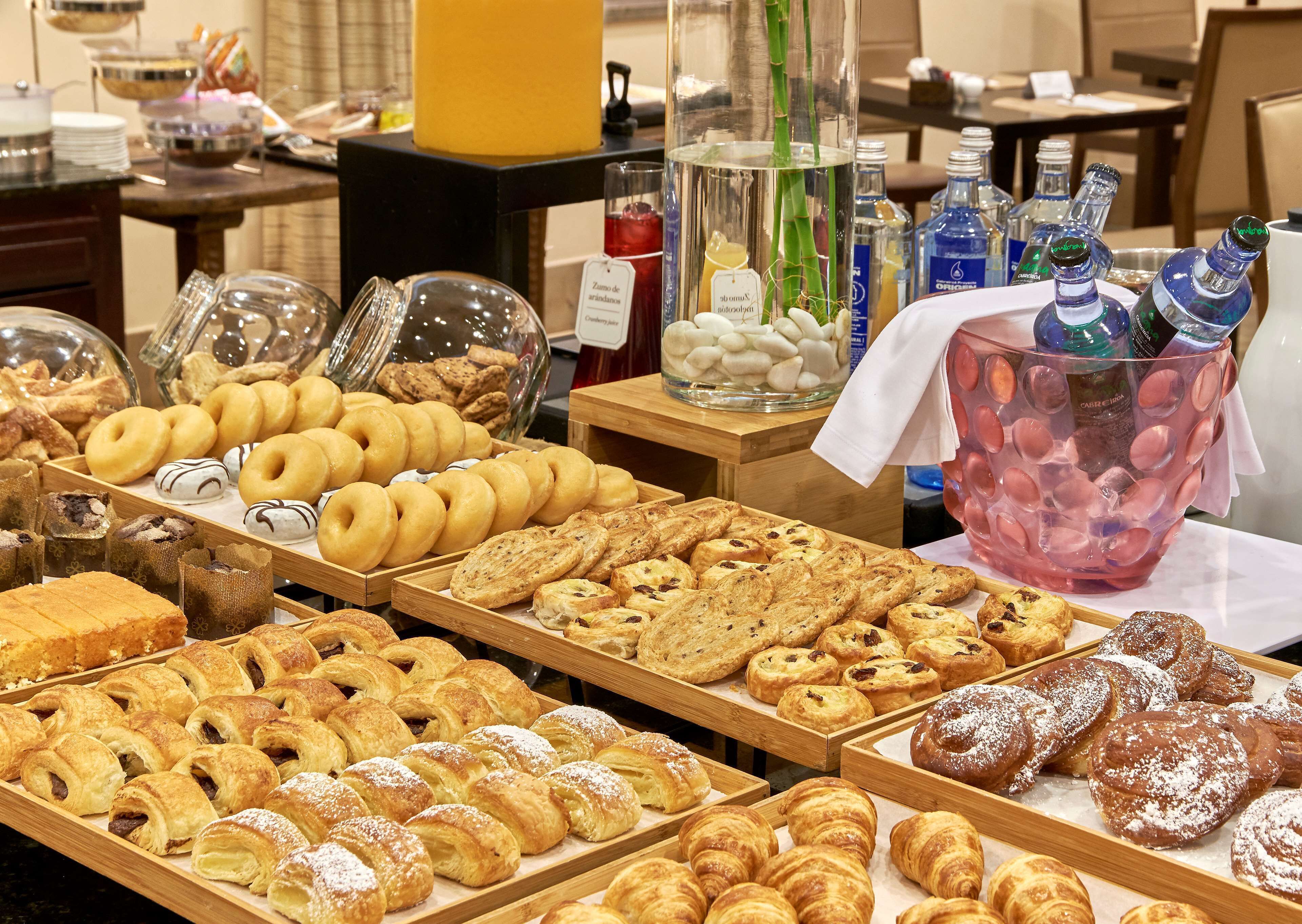 A bakery display with various pastries and a beverage cooler.