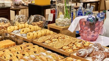 A bakery display with various pastries and a beverage cooler.