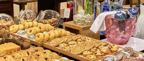 A bakery display with various pastries and a beverage cooler.