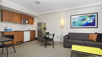 A compact living space with a kitchenette, dining area, and seating area.