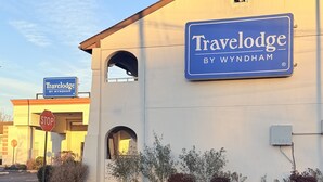 A Travelodge by Wyndham sign on a building.