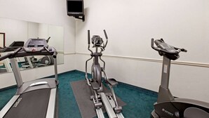 A gym with treadmills, an elliptical, and a stationary bike.