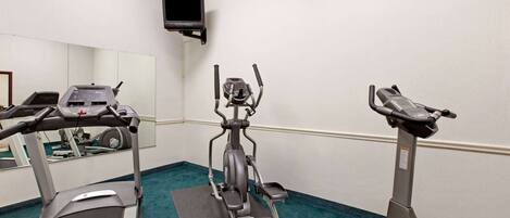 A gym with treadmills, an elliptical, and a stationary bike.