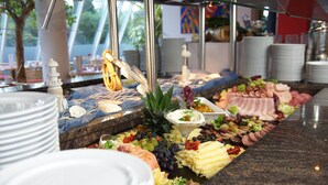A buffet with various food items and a decorative centerpiece.