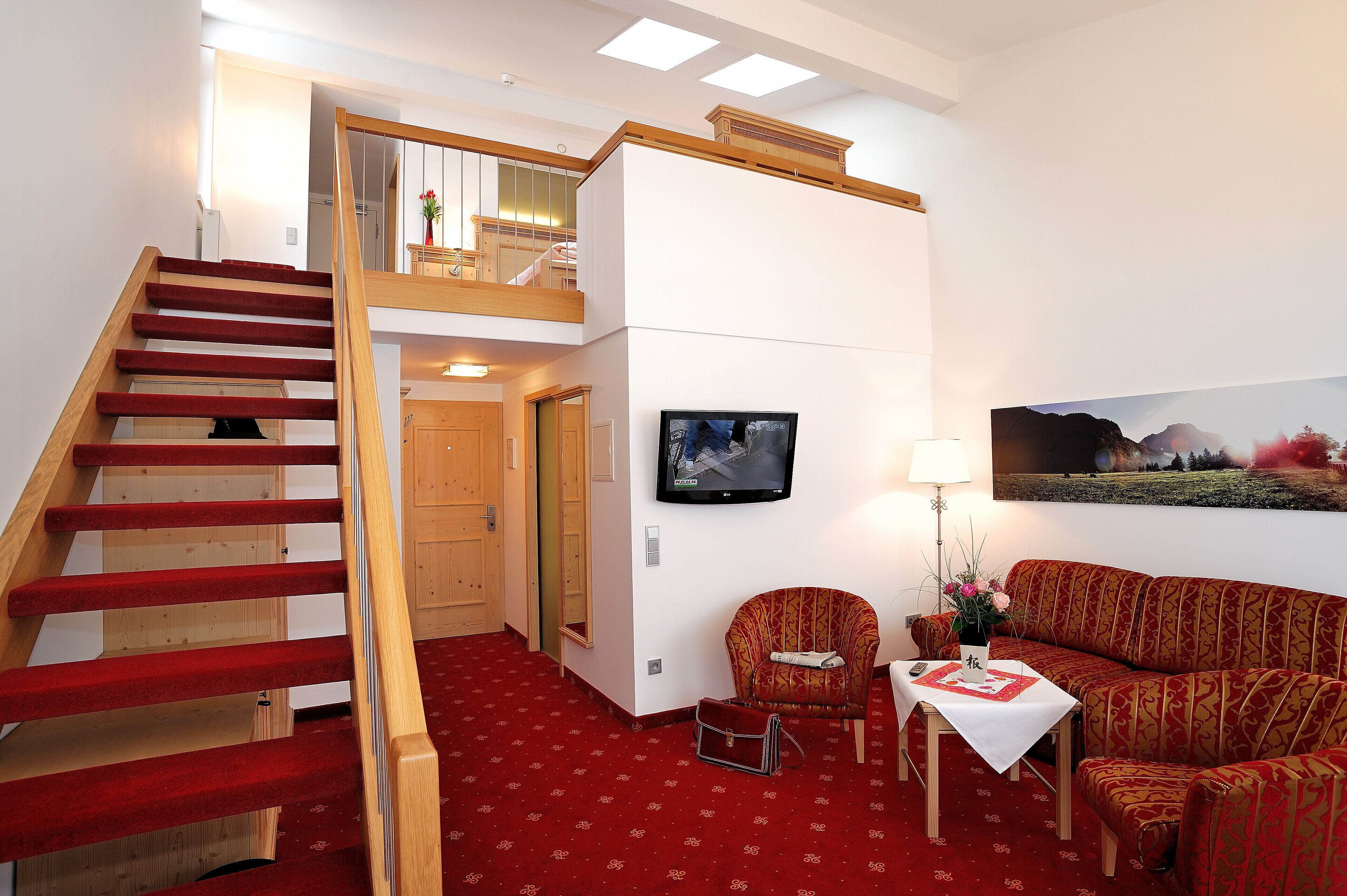 junior suite | living area | 12-inch flat-screen tv with satellite channels, tv, ipod dock