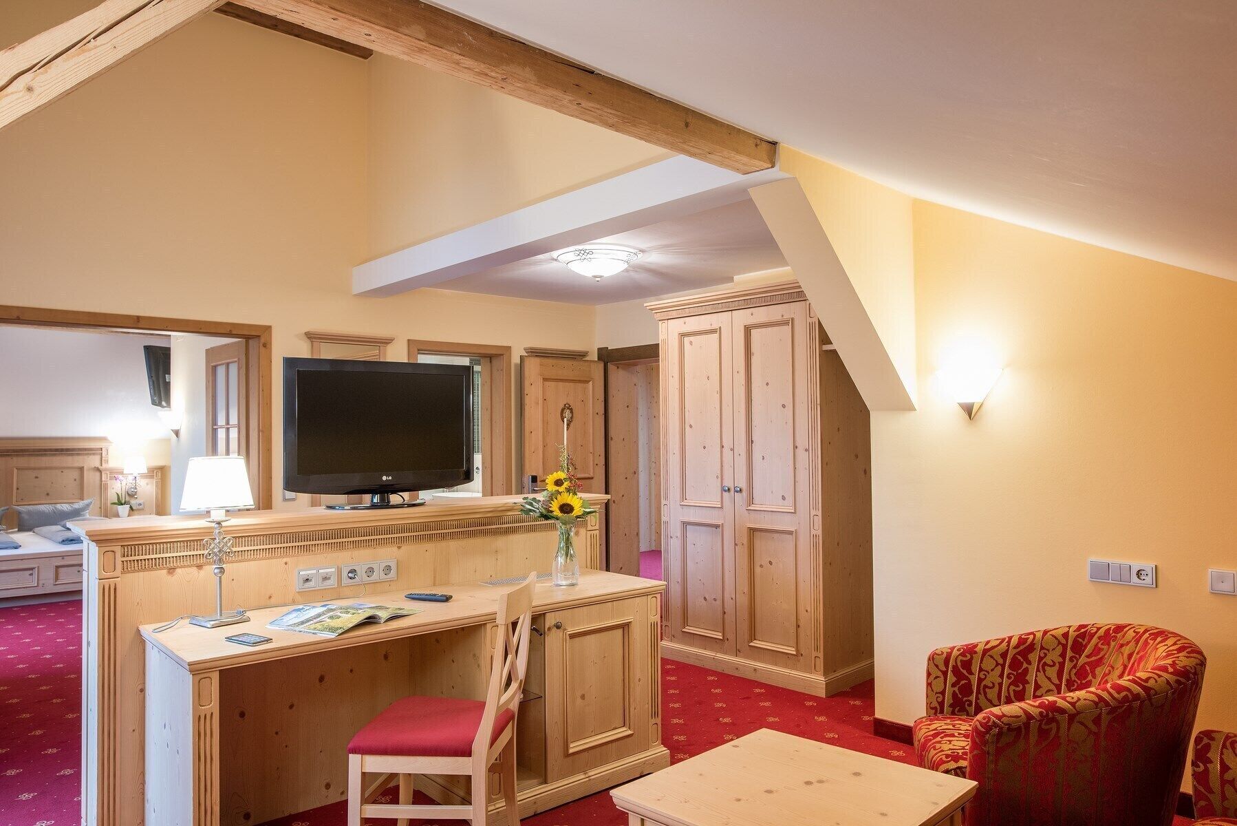 junior suite | living area | 12-inch flat-screen tv with satellite channels, tv, ipod dock
