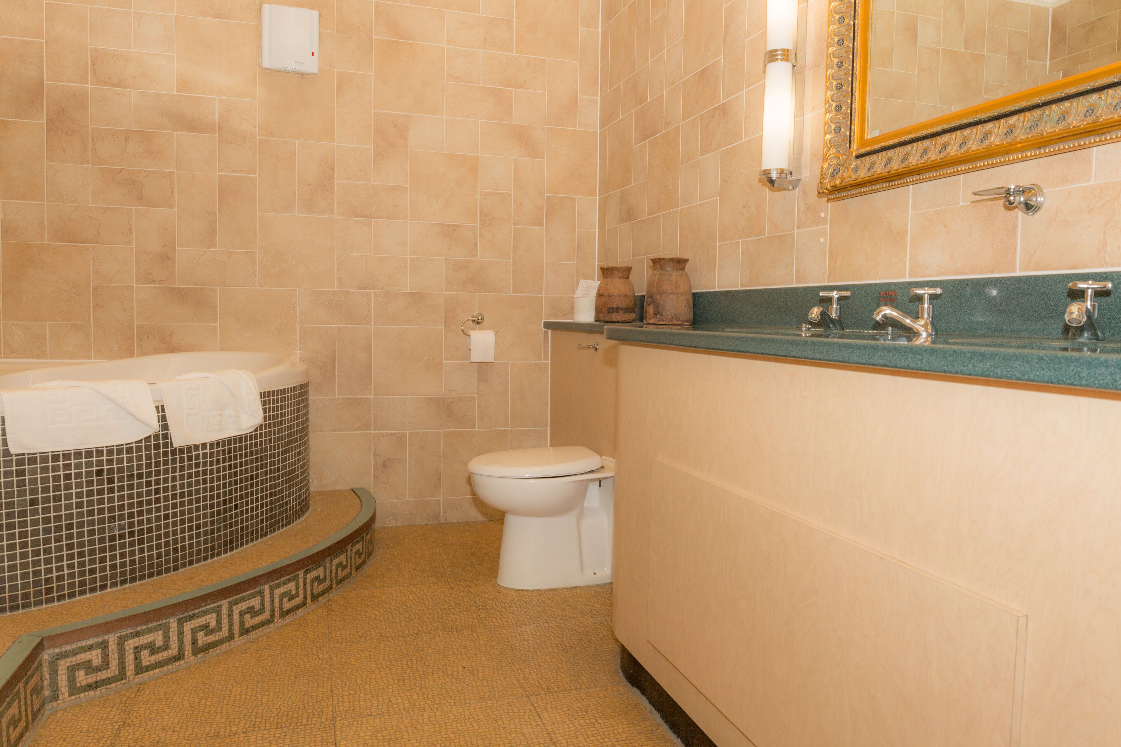 A bathroom with a bathtub, toilet, and sink.