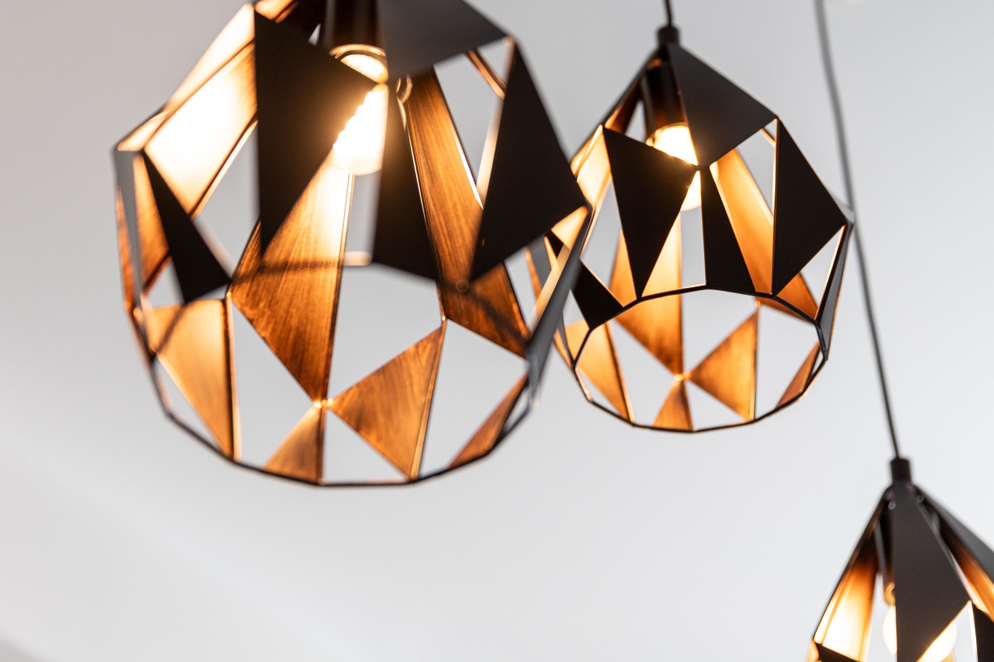 A geometric pendant light fixture with a warm glow.