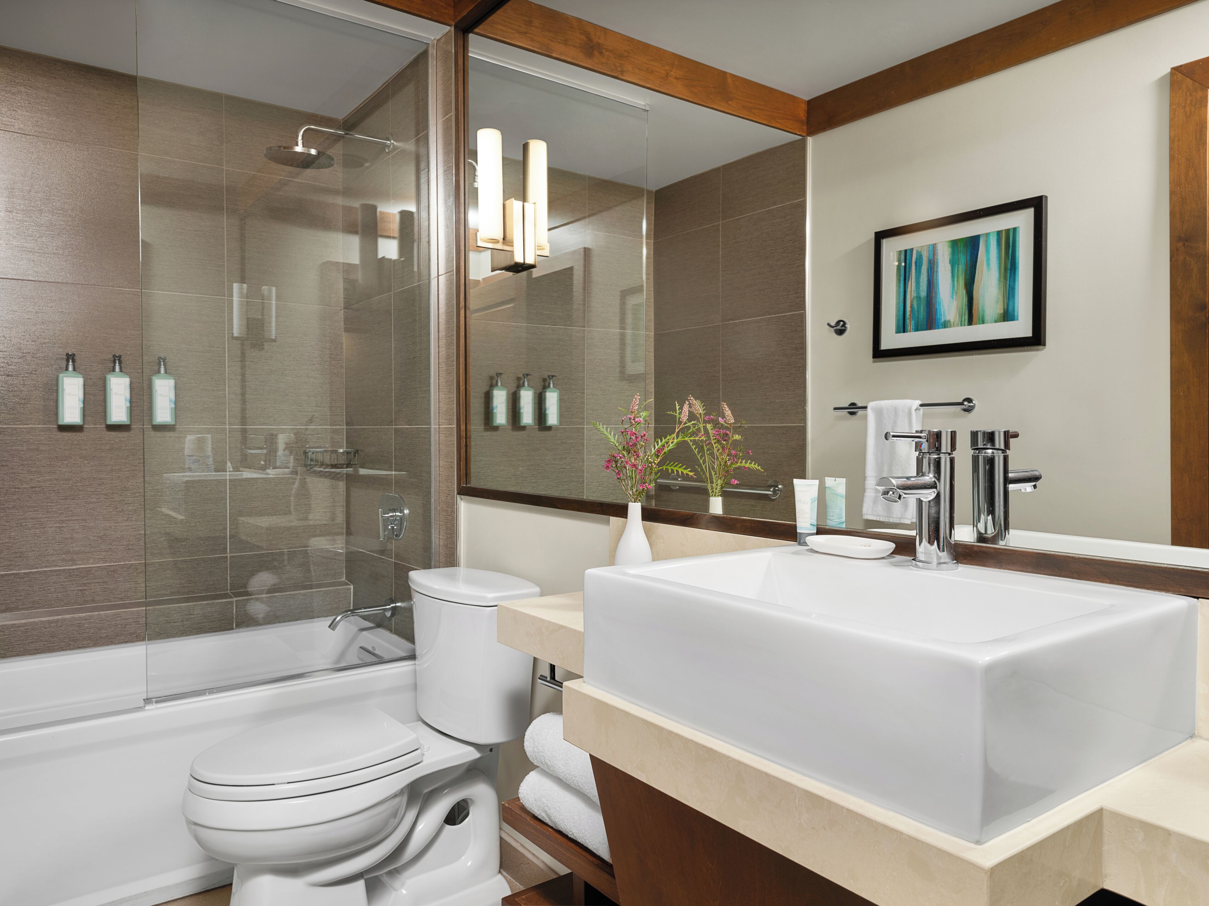 A modern bathroom with a bathtub, toilet, and sink.