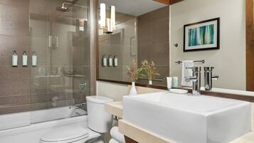 A modern bathroom with a bathtub, toilet, and sink.