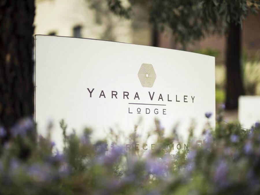 A sign for Yarra Valley Lodge with a logo and name.