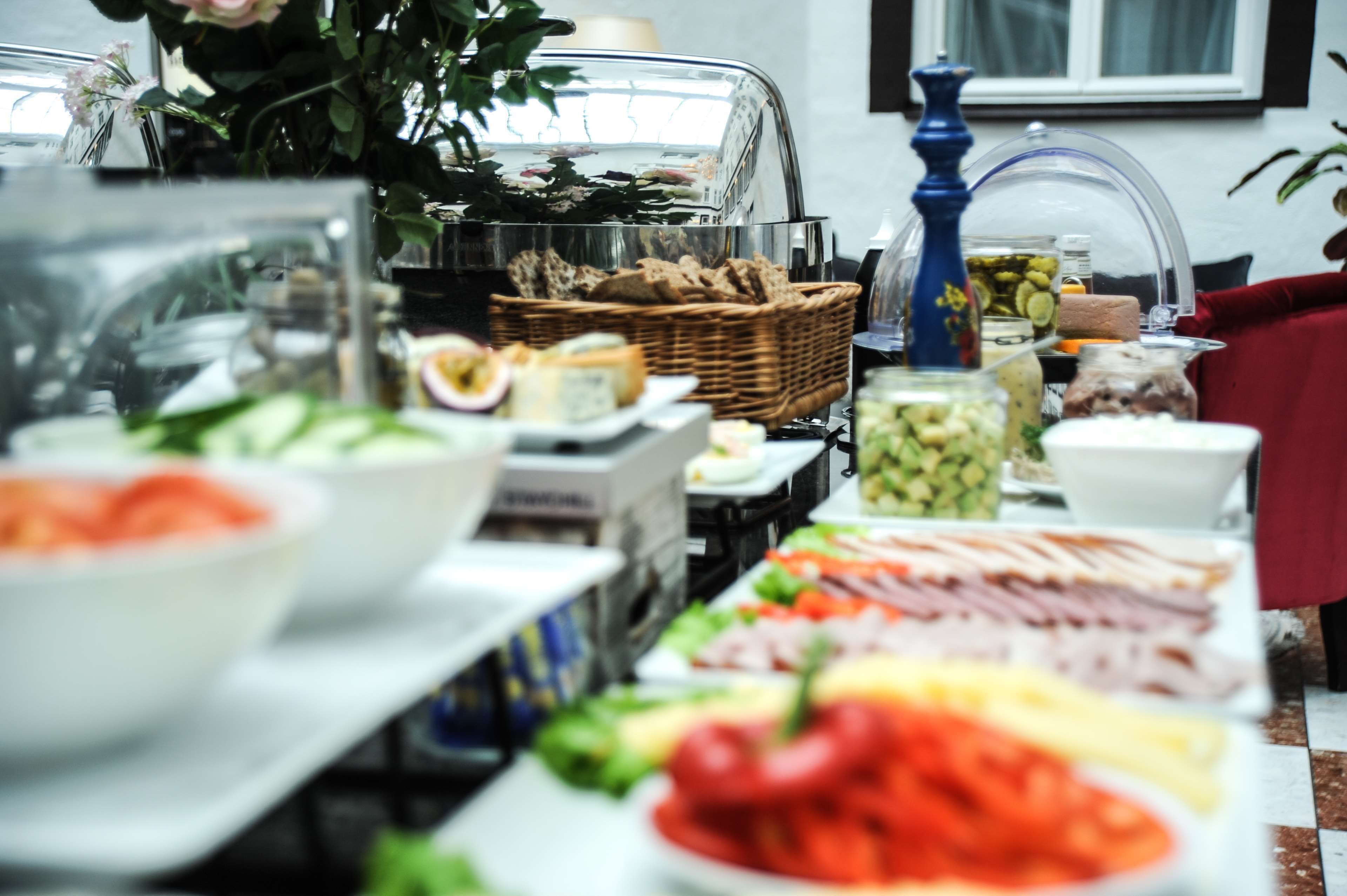 A buffet table with various food items and a coffee station.