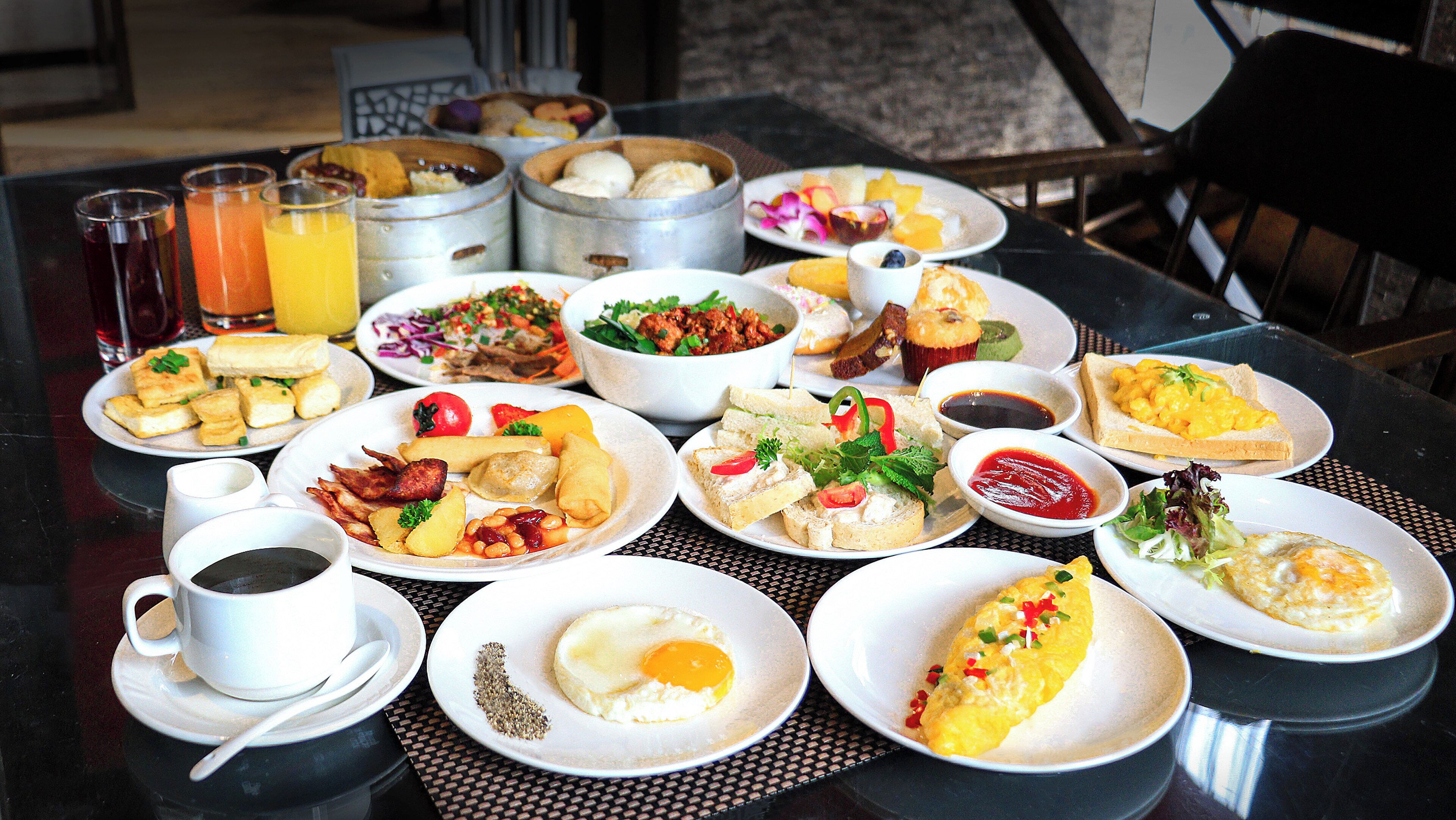 A breakfast buffet with various dishes and beverages.