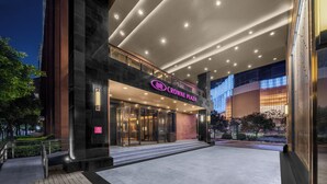 The exterior of Crowne Plaza hotel with a modern facade, large glass entrance, and illuminated signage. - Crowne Plaza Kunming City Centre by IHG (Kunming)