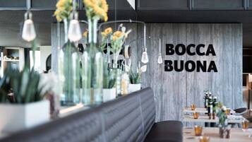 A modern interior with a wooden wall and the text "BOCCA BUONA" in bold letters.