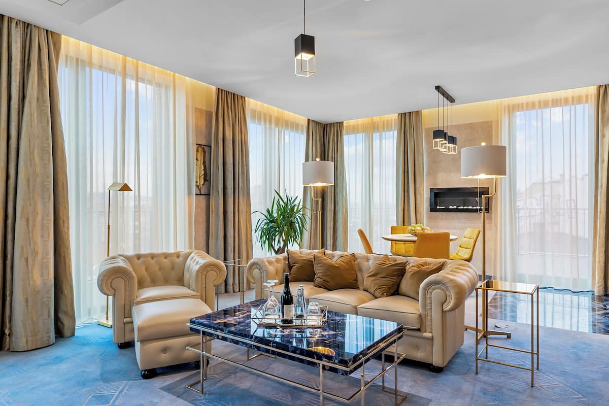 A modern living room with a sofa, coffee table, and a TV mounted on the wall.
