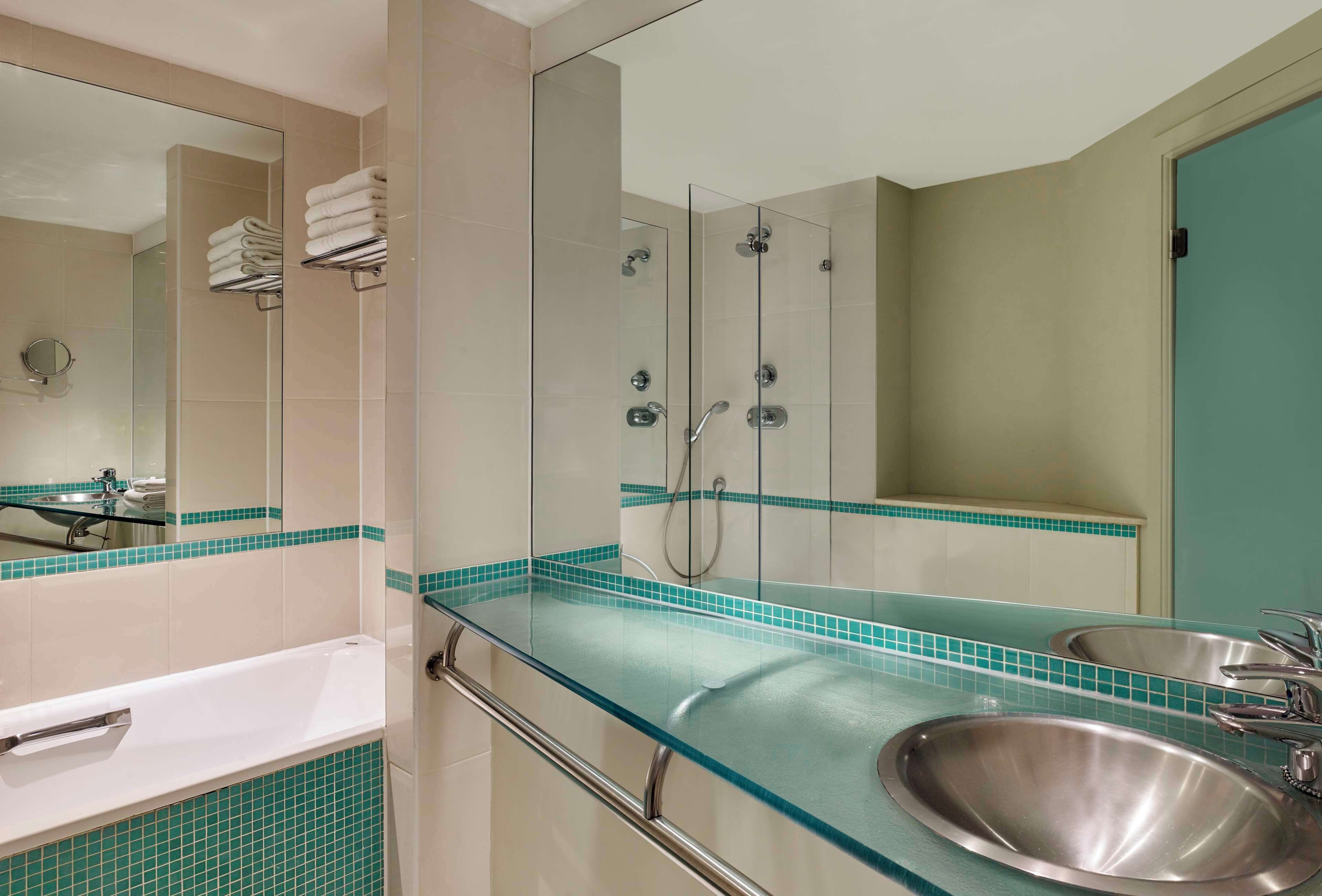 combined shower/bathtub, designer toiletries, hair dryer, towels