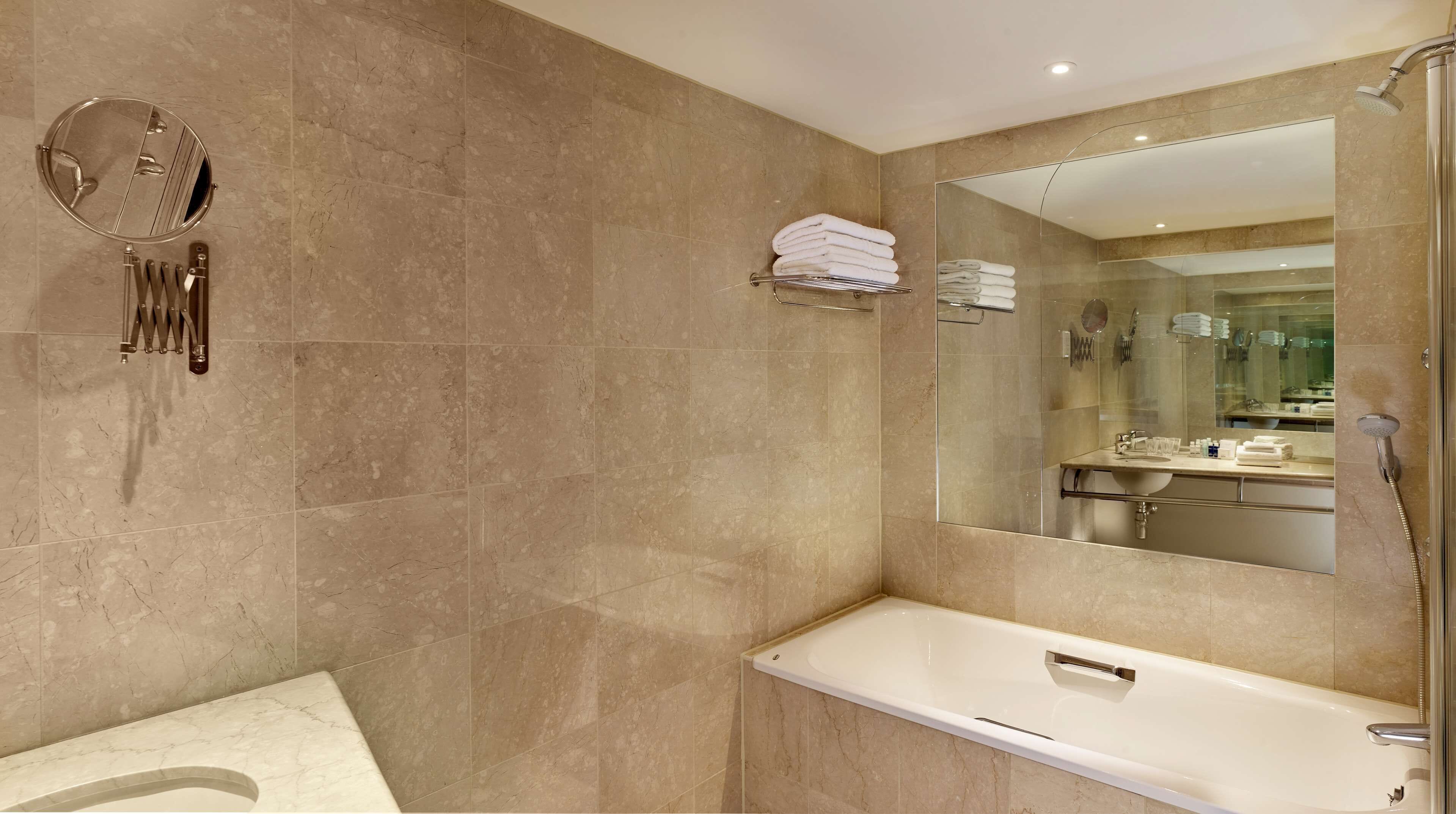 combined shower/bathtub, designer toiletries, hair dryer, towels