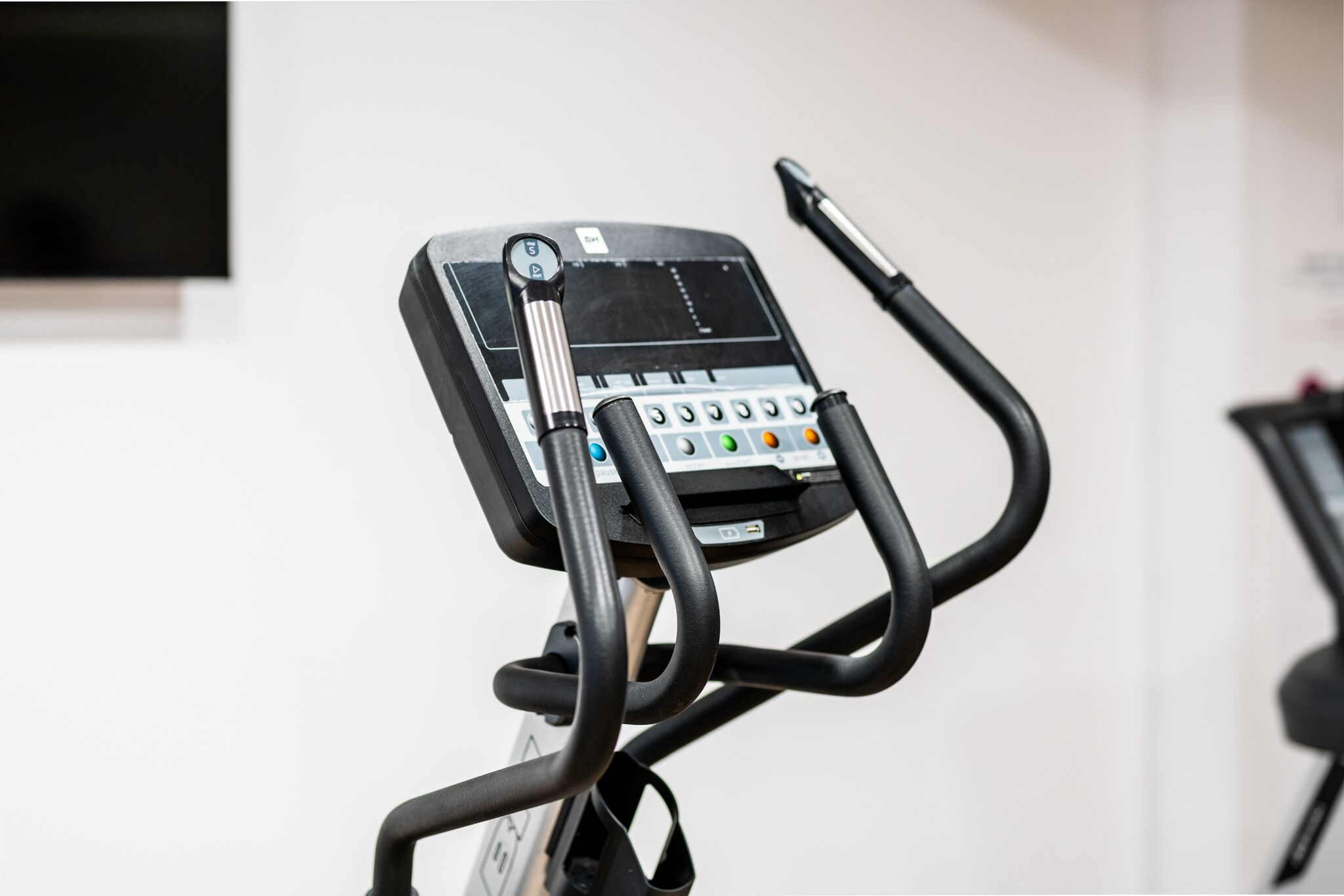 A stationary exercise bike with a digital display and control panel.