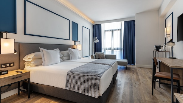 A hotel room with a large bed, bedside tables, a desk, and a chair. - Hotel LIVVO Fataga (Las Palmas de Gran Canaria)