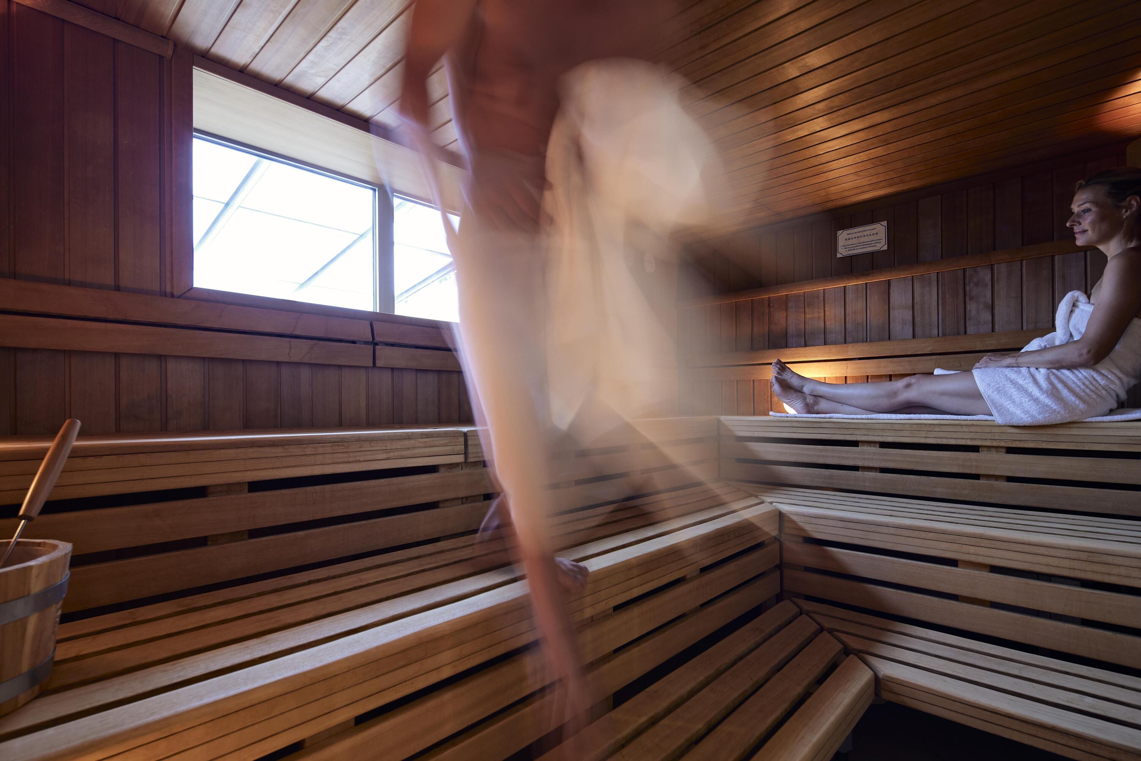 A sauna with wooden benches and a window.