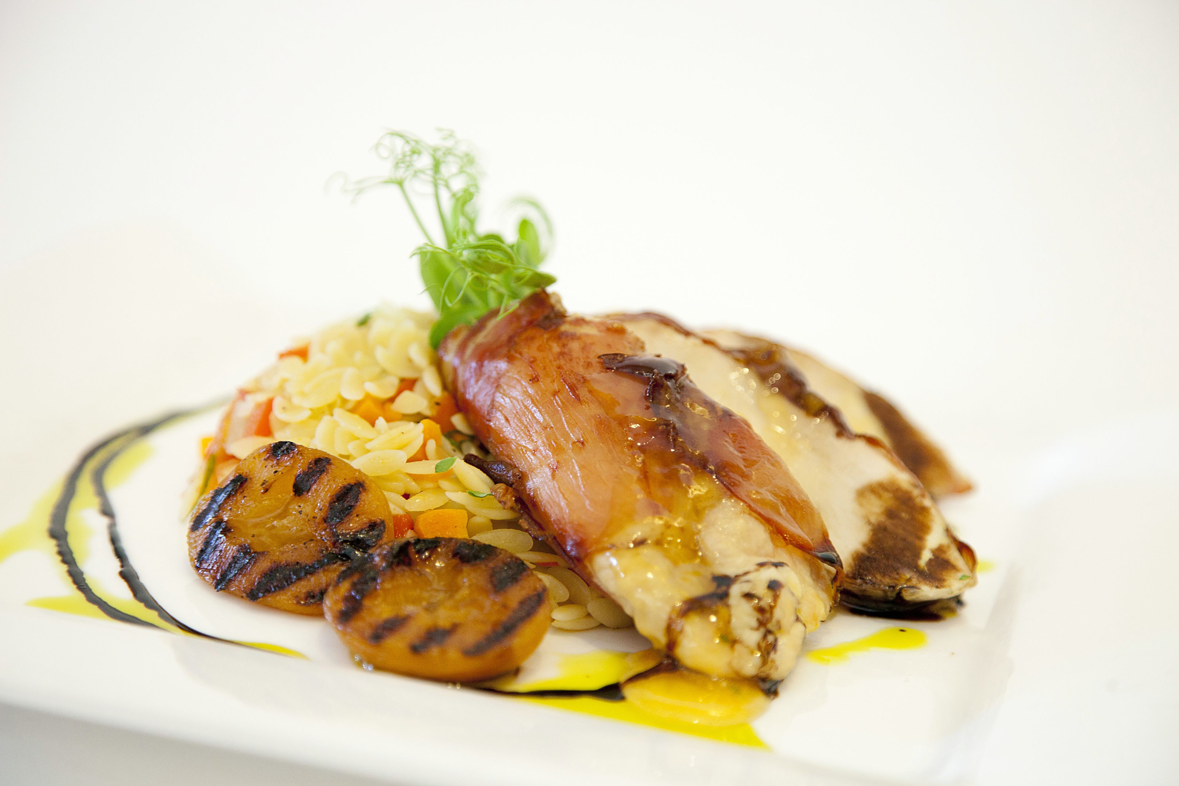 A plate of food with grilled vegetables and a piece of meat.
