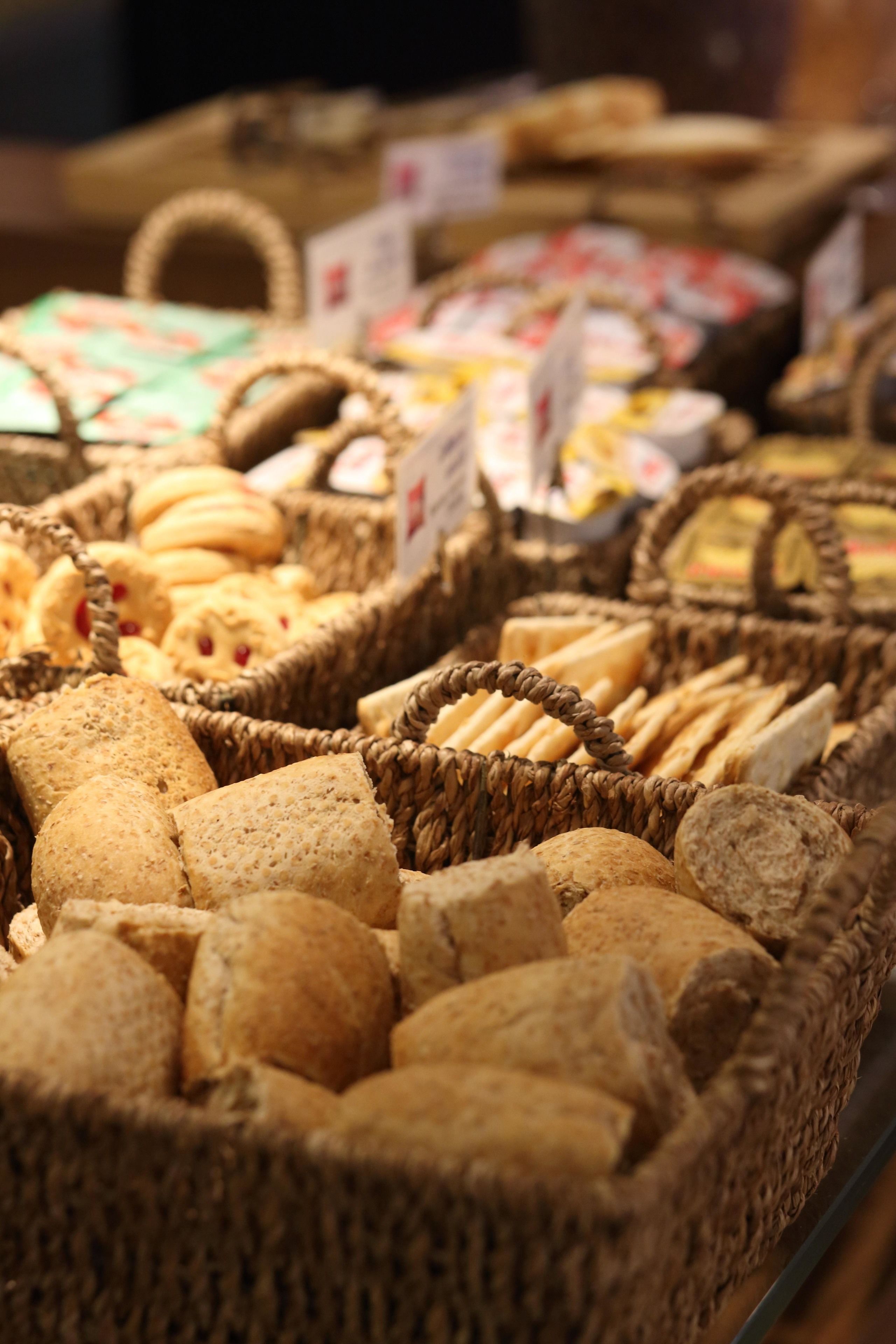 A display of various baked goods in wicker baskets.