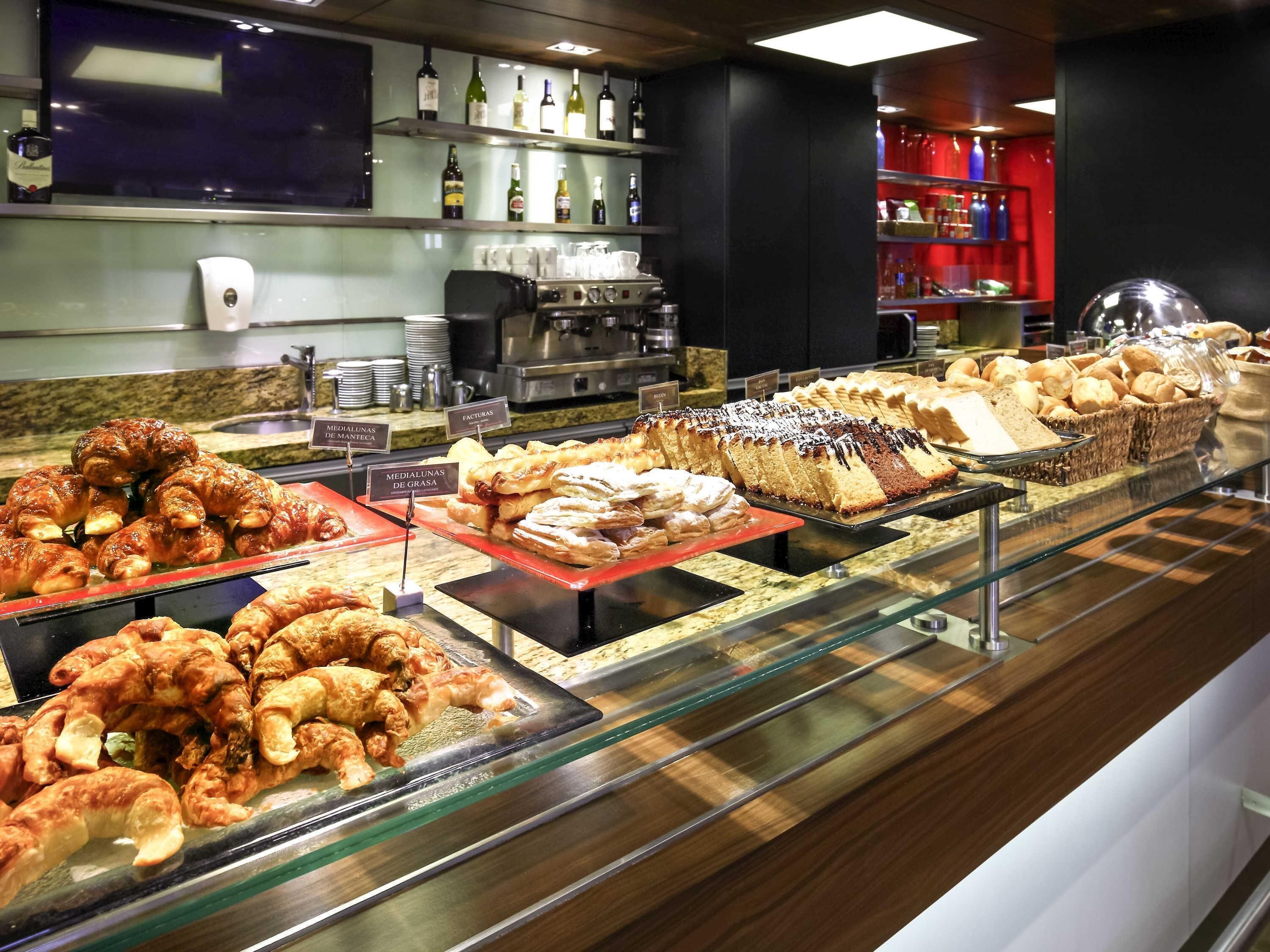 A bakery display with various pastries and bread.