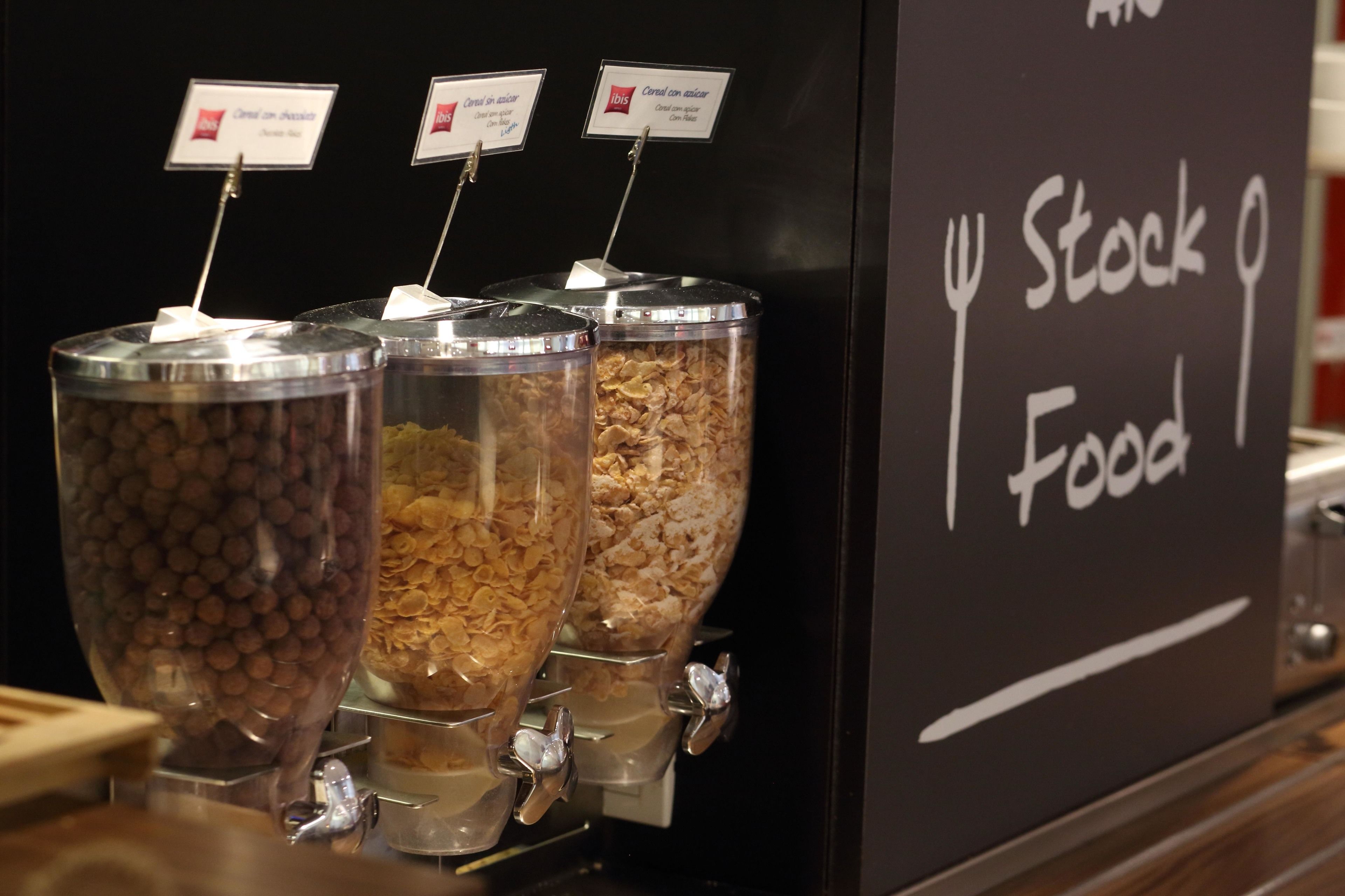 Un distribuidor de alimentos con contenedores etiquetados para distintos tipos de cereales.