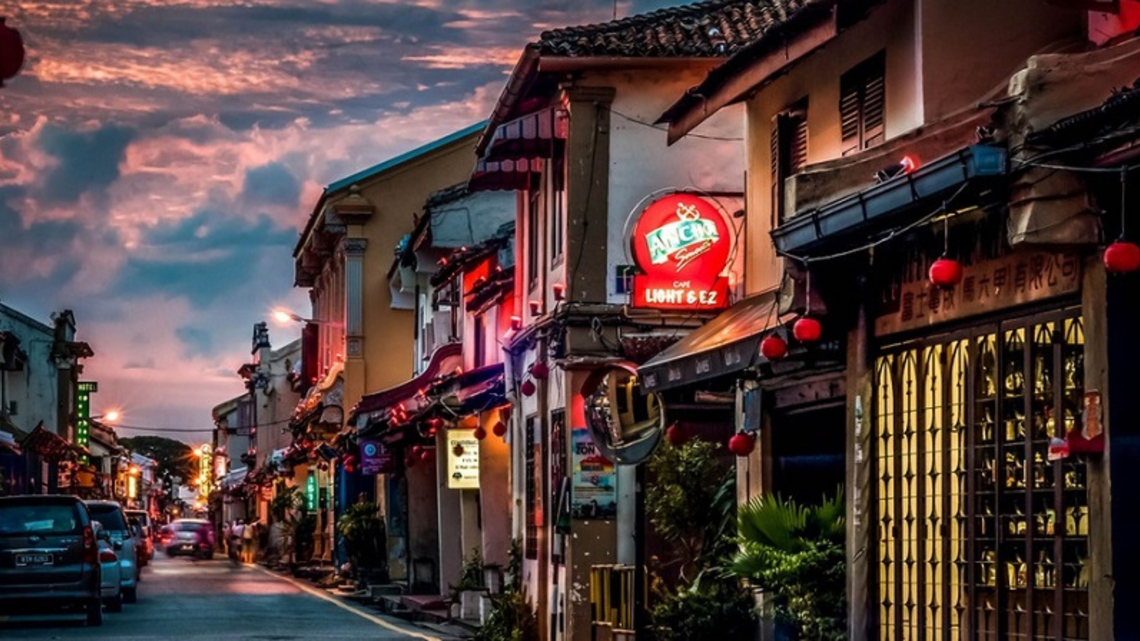 Una calle flanqueada por edificios tradicionales, un llamativo letrero rojo de Angada Light & Ice, y un escaparate con un letrero en idioma extranjero.