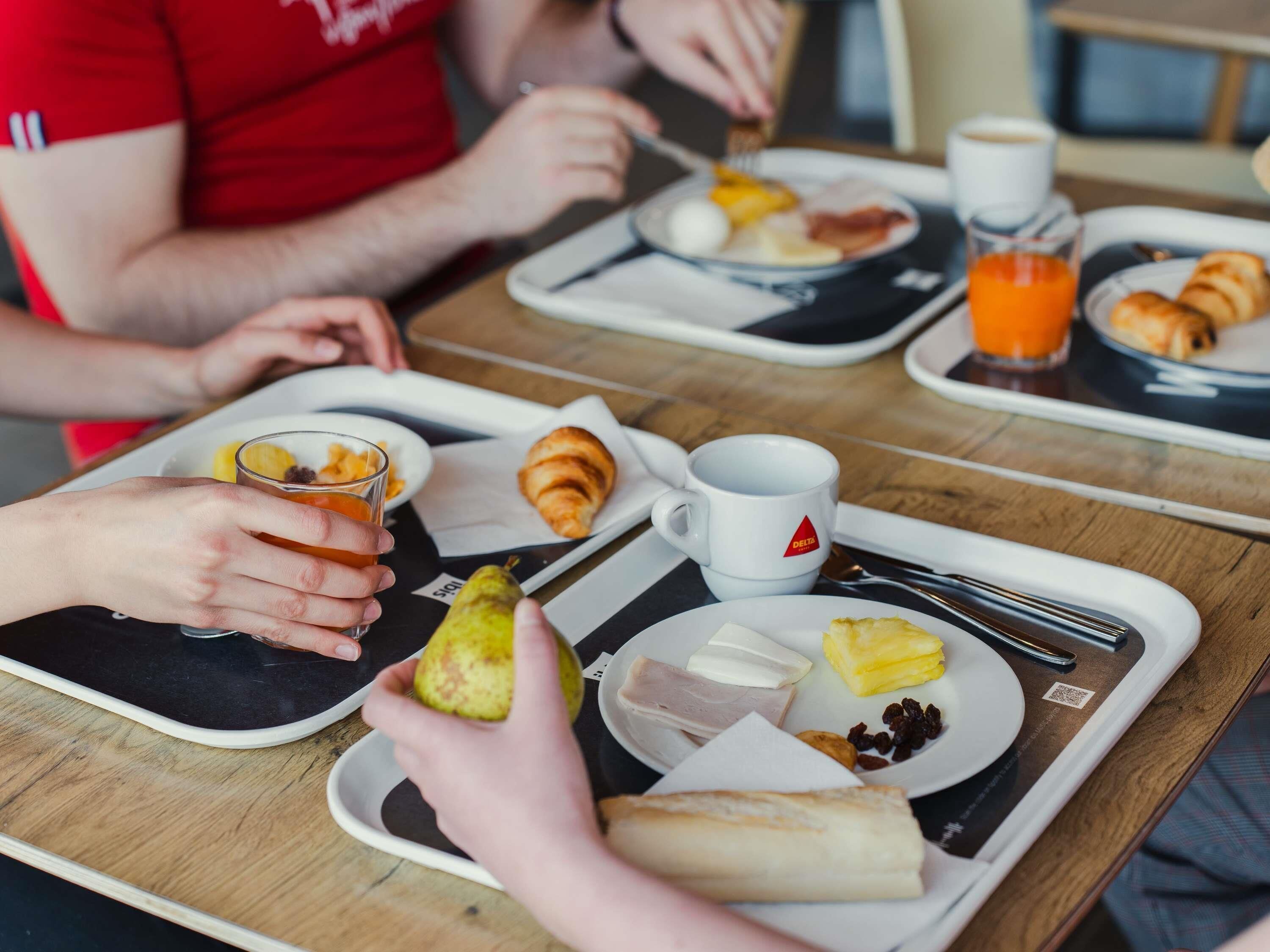 A breakfast tray with food items and a mug.