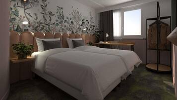 A modern bedroom with a large bed, a desk, and a chair.